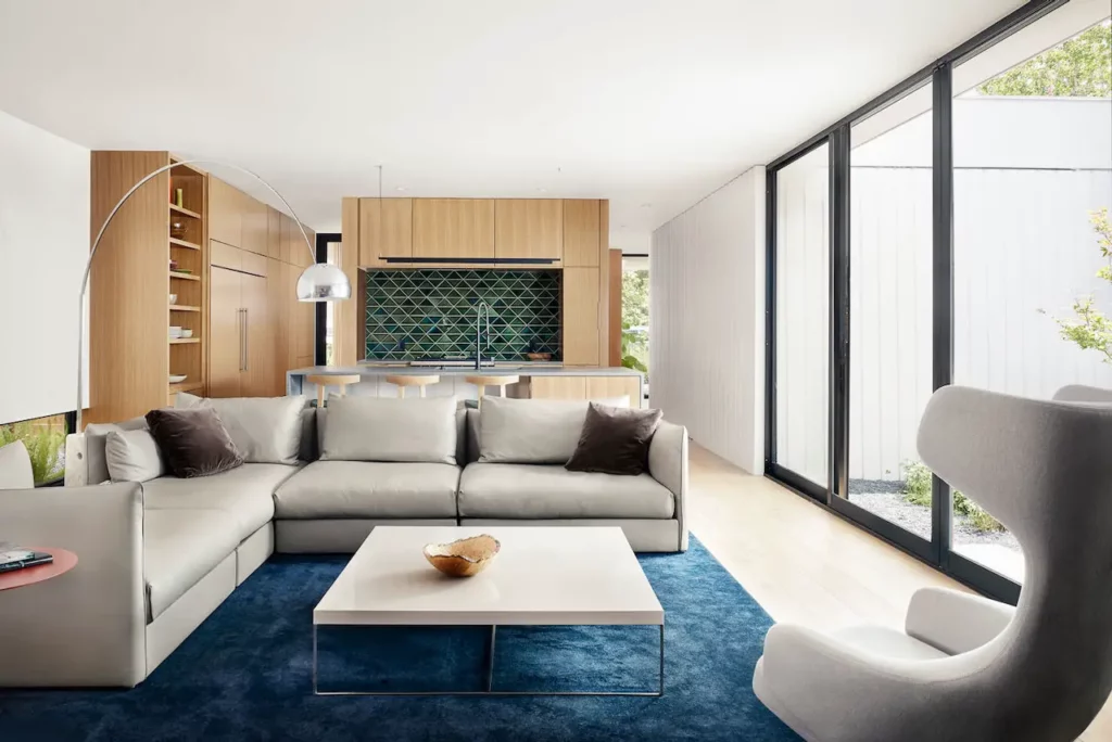 Looking for a modern living room with wooden floors and a blue rug? Contact an Austin Realtor to help you with your home buying journey.