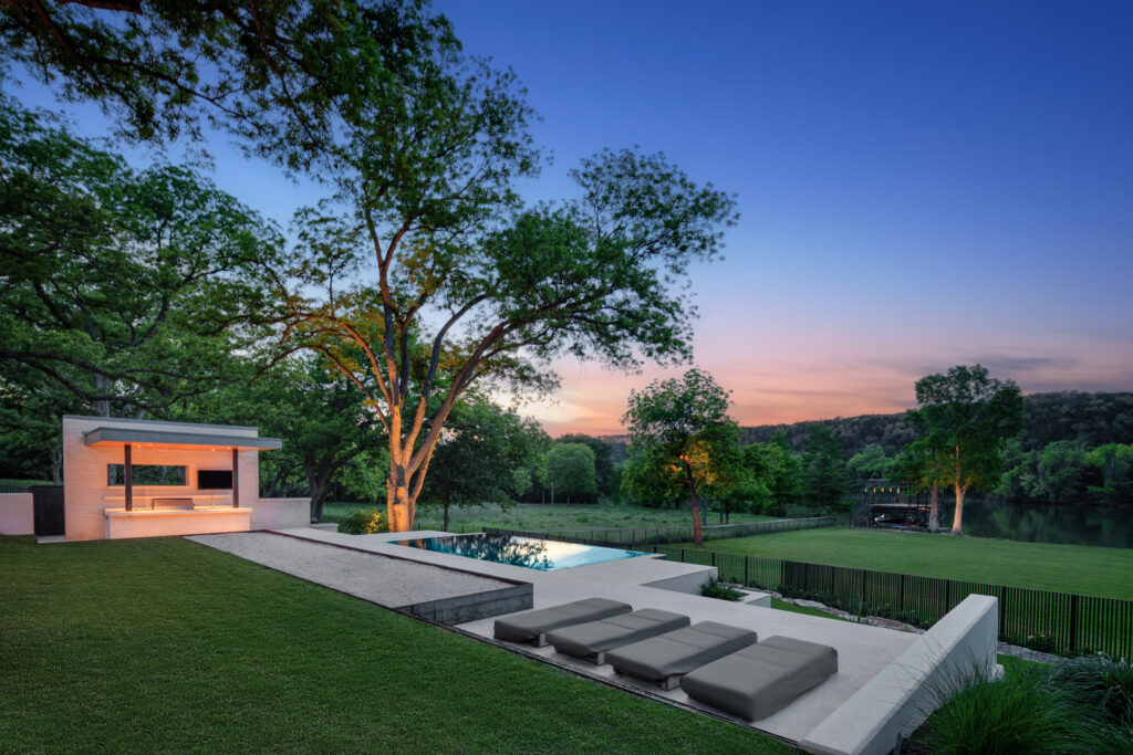 A modern backyard with a pool and lounge chairs perfect for homebuyers looking for relaxation.