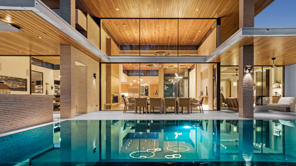 Agent Find - A modern house with a swimming pool and glass walls can be found in this real estate chat.