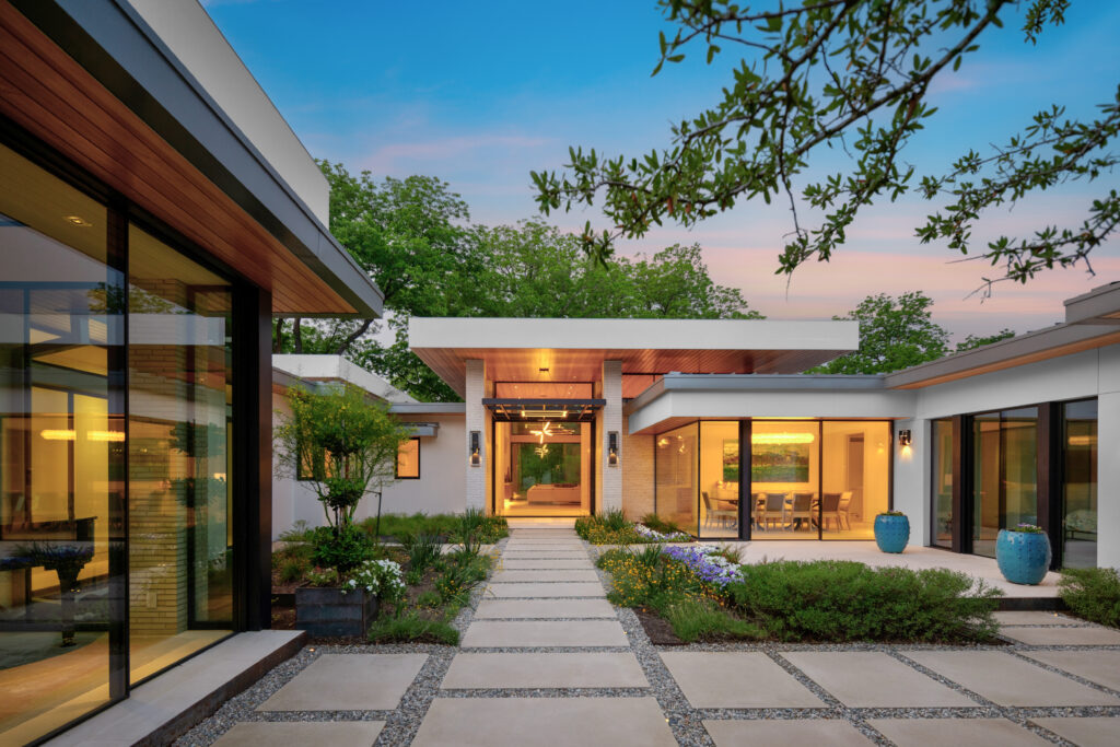 A modern home with a glass walkway, perfect for those looking to sell their property in Austin.
