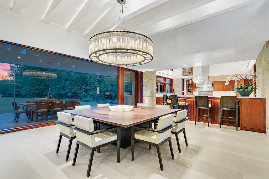A modern dining room with a chandelier is a must-see for home buyers.