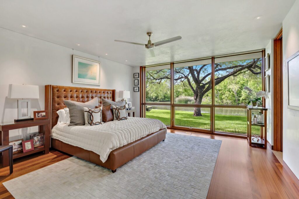 Looking for a bedroom with hardwood floors and a view of the outdoors? Contact our Austin Realtor today to find your dream home!