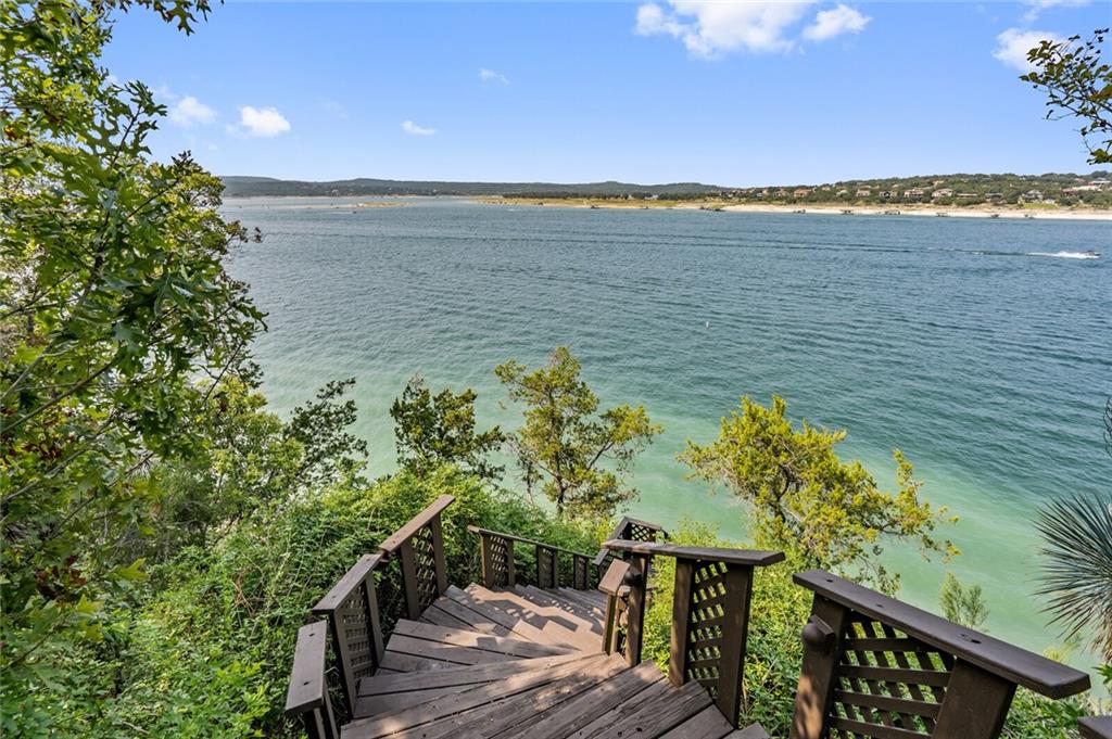 A wooden staircase leading to a body of water, perfect for real estate opportunities in Austin.