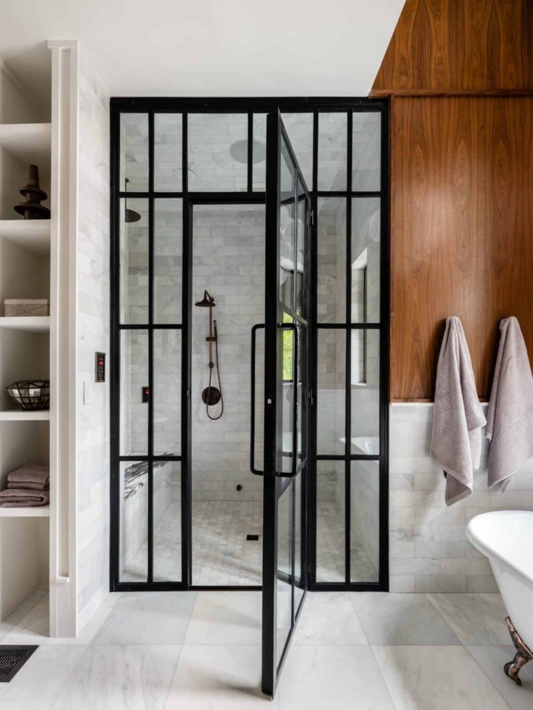 A modern bathroom with a glass shower door, perfect for home buyers looking in the Austin area.