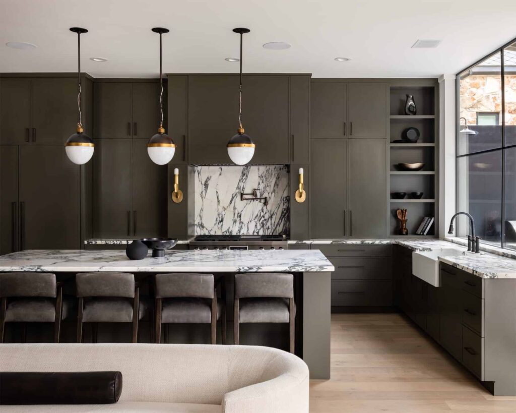 A modern kitchen with black cabinets and marble countertops is the perfect space for homebuyers looking for a sleek and elegant design. Choose this listing to show your agent during your real estate chat.