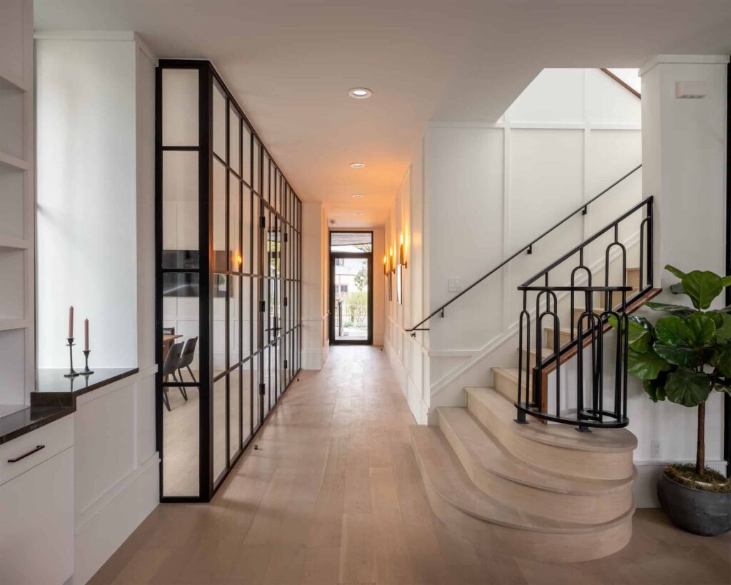 Looking for a home in Austin? Check out this hallway with a staircase and sleek black railings. Contact us today for more information! #AustinRealtor #HomeBuying #RealEstateChat