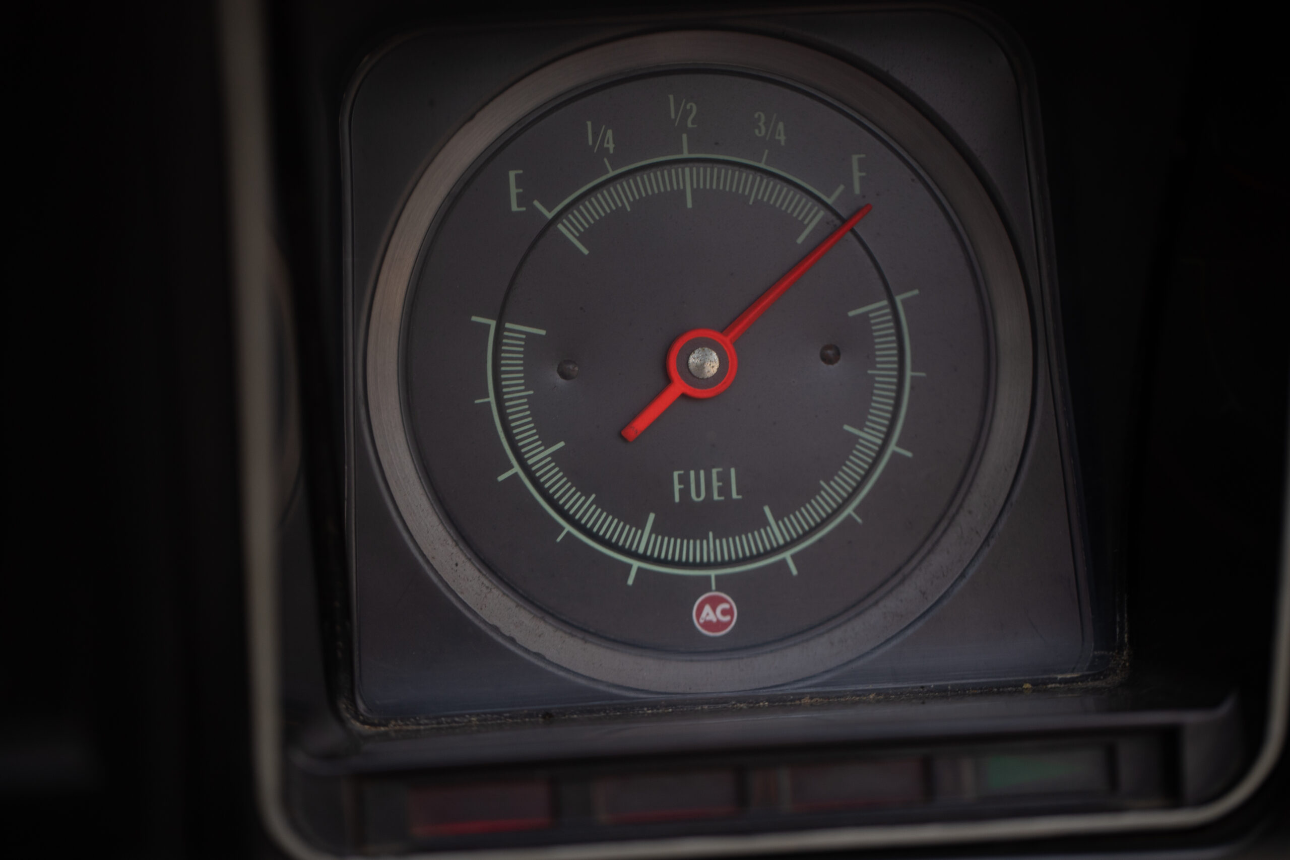Analog fuel gauge in a vehicle showing a full tank (needle pointing to "F").